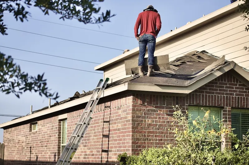 Professional roofer working on a residential roof in McKinleyville